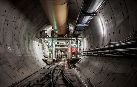 Construction lot "H41 Sill Gorge-Pfons": last backup unit of TBM Ida with the arrival area of the supply train and loading area in the lower part of the picture, at the top air supply and conveyor belt, on the right hand side the water and electrical energy supply